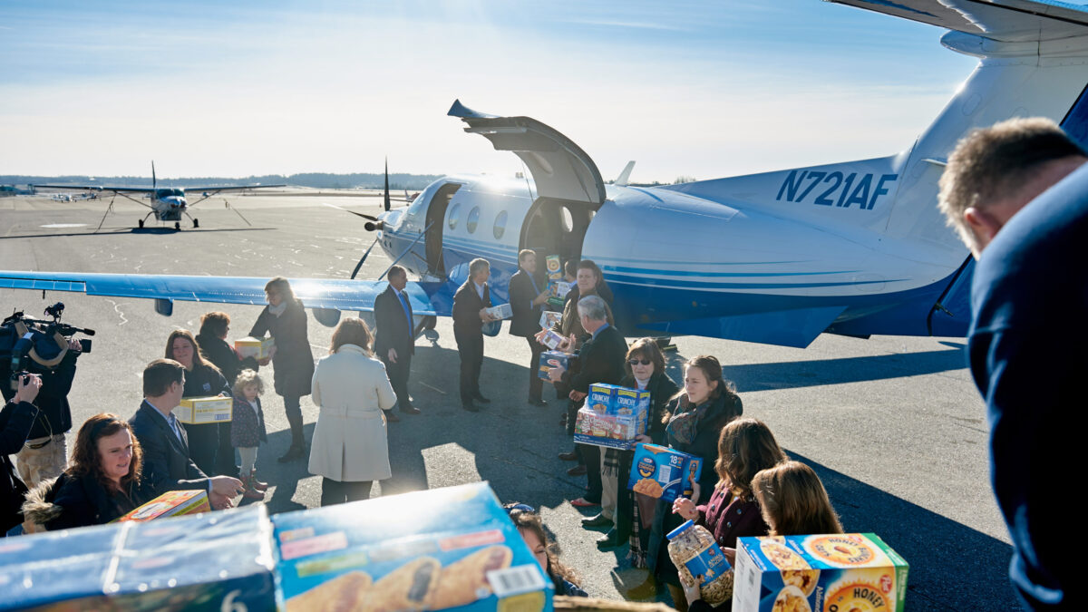 Loading a PlaneSense PC-12 with donations for NH Food Bank